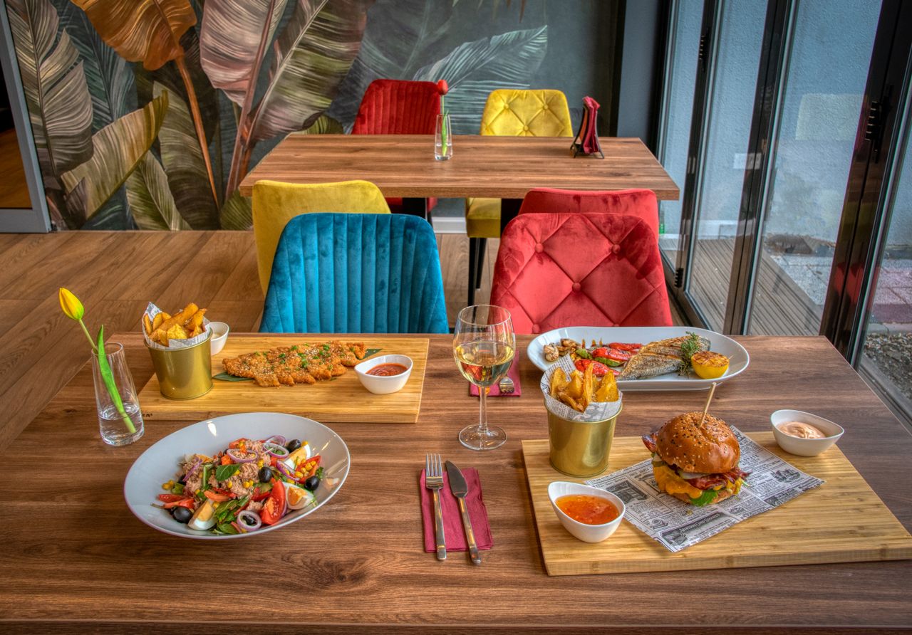 Colorful dining setup in a modern restaurant featuring diverse meals and vivid decor.