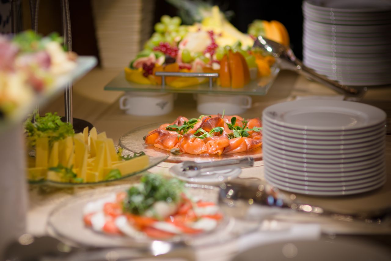 Luxurious buffet setting featuring smoked salmon, fresh fruits, and cheese platters.
