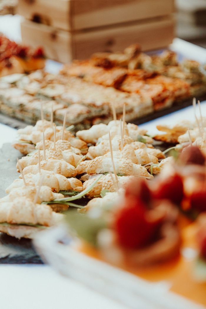 Close-up of assorted finger foods with appetizers and desserts for an event.